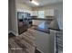 Modern kitchen with stainless steel appliances, granite countertop, white cabinets, and modern wood-look flooring at 340 Kiskadee Loop, Conway, SC 29526
