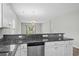 Open kitchen with granite countertops, stainless steel dishwasher, and view to the living area at 340 Kiskadee Loop, Conway, SC 29526