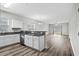 Well-lit kitchen with granite counters, white cabinets, and a view into the living space at 340 Kiskadee Loop, Conway, SC 29526