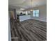 Spacious living room with wood-look flooring and lots of light features an eat-in kitchen with stainless steel appliances at 340 Kiskadee Loop, Conway, SC 29526