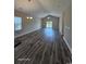 Open-concept living room featuring vaulted ceiling, wood-look flooring, and a sliding glass door with balcony access at 340 Kiskadee Loop, Conway, SC 29526