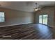 Bright living room featuring wood floors, ceiling fan and sliding glass doors to a balcony at 340 Kiskadee Loop, Conway, SC 29526