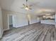 Open-concept living space with wood floors, high ceilings, and an inviting view to the kitchen at 340 Kiskadee Loop, Conway, SC 29526