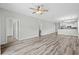 Spacious living room with wood-look flooring, neutral paint, and bright lighting fixtures at 340 Kiskadee Loop, Conway, SC 29526