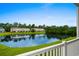 Beautiful water view from a balcony overlooking a calm lake, lush green landscaping, and several residential buildings at 340 Kiskadee Loop, Conway, SC 29526