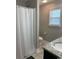 Functional bathroom featuring a shower curtain, granite counter, and a window for natural light at 387 Blue Rock Dr., Longs, SC 29568