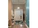 Bright foyer features stylish rug, decorative table with lamp, and adjacent entry door at 387 Blue Rock Dr., Longs, SC 29568