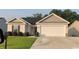 Charming single-story home with neutral siding, well-manicured lawn, and attached two-car garage at 387 Blue Rock Dr., Longs, SC 29568