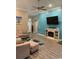 Open-concept living room boasts modern fireplace, recessed lighting, and an accent wall at 387 Blue Rock Dr., Longs, SC 29568