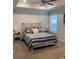 Relaxing main bedroom with a bed and tray ceilings, complemented by bedside tables and lamps at 387 Blue Rock Dr., Longs, SC 29568