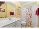 Bathroom with yellow walls, a white vanity and a shower with a patterned curtain at 396 Mckendree Ln., Myrtle Beach, SC 29579