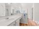 A pristine bathroom with double sinks, spacious vanity, and wood-look flooring at 396 Mckendree Ln., Myrtle Beach, SC 29579