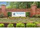 Entrance sign for Inverness surrounded by colorful flowers, lush greenery, and brick columns at 396 Mckendree Ln., Myrtle Beach, SC 29579