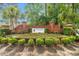 Community sign for Inverness set in a brick structure with palm trees and colorful landscaping at 396 Mckendree Ln., Myrtle Beach, SC 29579