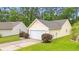 Exterior of home with a two-car garage, well-manicured lawn, and shrubbery at 396 Mckendree Ln., Myrtle Beach, SC 29579