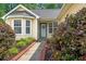 Charming home entrance with a wreath on the door, manicured landscaping, and a welcoming walkway at 396 Mckendree Ln., Myrtle Beach, SC 29579
