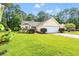 Well-manicured front yard with lush green lawn and colorful landscaping, enhancing curb appeal at 396 Mckendree Ln., Myrtle Beach, SC 29579