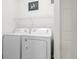 Convenient laundry area with stacked washer and dryer and wire shelving, offering practical space at 396 Mckendree Ln., Myrtle Beach, SC 29579