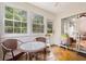 Bright sun room features multiple windows, providing natural light and pleasant views with a table and chairs at 396 Mckendree Ln., Myrtle Beach, SC 29579