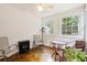 Bright sun room features multiple windows, providing natural light and pleasant views with a table and chairs at 396 Mckendree Ln., Myrtle Beach, SC 29579