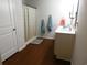 Bright bathroom with white vanity, wood-look floors, and shower-tub combination with stylish patterned shower curtain at 401 Quinta St., Longs, SC 29568