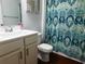 Bathroom featuring white sink vanity and bright shower curtain in a well-lit interior space at 401 Quinta St., Longs, SC 29568