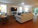 Spacious living room with hardwood floors, ample natural light, and access to the backyard at 401 Quinta St., Longs, SC 29568