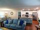 Open-concept living room with hardwood floors seamlessly connecting to the kitchen and dining area at 401 Quinta St., Longs, SC 29568