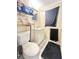 Compact bathroom with a white toilet, sink, and storage shelf for towels at 403 6Th Ave. S, Myrtle Beach, SC 29577