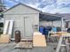 A view of the home's exterior, surrounded by various items including trash cans and wooden boards at 403 6Th Ave. S, Myrtle Beach, SC 29577