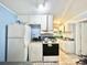 Kitchen area with basic appliances and overhead cabinets, offering essential cooking amenities at 403 6Th Ave. S, Myrtle Beach, SC 29577