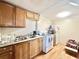 Functional kitchen with wooden cabinets, a white electric stove, and standard appliances on a wooden floor at 403 6Th Ave. S, Myrtle Beach, SC 29577