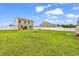 Spacious, fully fenced backyard featuring a lush lawn, fire pit, and storage shed at 408 Carmello Circle, Conway, SC 29526