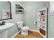Stylish powder room with pedestal sink, decorative shelves, and charming coastal-themed decor at 408 Carmello Circle, Conway, SC 29526