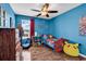 Blue bedroom with a single bed, wood floors, and superhero decorations at 408 Carmello Circle, Conway, SC 29526