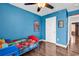 Blue bedroom showing a single bed with superhero decor and a view to the hallway at 408 Carmello Circle, Conway, SC 29526