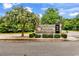 Elegant stone community sign with manicured landscaping and flowering trees at 408 Carmello Circle, Conway, SC 29526