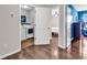 View of a hallway with access to a bedroom and the laundry room, showcasing hardwood floors at 408 Carmello Circle, Conway, SC 29526