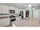 Modern kitchen featuring granite countertops, stainless steel appliances, and a spacious island with a sink at 408 Carmello Circle, Conway, SC 29526