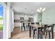 Well-lit kitchen area with seating around the island, stainless steel appliances, and an adjacent dining space at 408 Carmello Circle, Conway, SC 29526