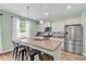 Well-lit kitchen featuring a granite island, stainless steel appliances, and ample cabinet space at 408 Carmello Circle, Conway, SC 29526