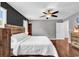 This main bedroom features a ceiling fan, neutral paint, and a rustic wood bed frame at 408 Carmello Circle, Conway, SC 29526