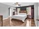 This main bedroom has a rustic wood bed frame, two windows, and a modern ceiling fan at 408 Carmello Circle, Conway, SC 29526