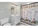 Cozy bathroom with a unique shower curtain featuring lighthouses and sailboats at 4103 N Ocean Blvd. # 707, North Myrtle Beach, SC 29582