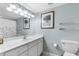 Bathroom featuring a white vanity, ample lighting, and beach-themed artwork at 4103 N Ocean Blvd. # 707, North Myrtle Beach, SC 29582