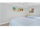 Bright bedroom featuring twin beds, coastal artwork, and a ceiling fan at 4103 N Ocean Blvd. # 707, North Myrtle Beach, SC 29582
