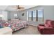 Cozy bedroom with a ceiling fan, large window with views, and a comfortable recliner chair at 4103 N Ocean Blvd. # 707, North Myrtle Beach, SC 29582