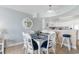 Stylish dining area features a glass-top table, wicker chairs, and an open layout connected to the kitchen at 4103 N Ocean Blvd. # 707, North Myrtle Beach, SC 29582