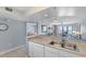 Well-lit kitchen featuring bar counter, seamlessly connected to the dining and living areas for an inclusive space at 4103 N Ocean Blvd. # 707, North Myrtle Beach, SC 29582