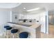 Bright and open kitchen with bar seating, white cabinets, and an adjacent hallway at 4103 N Ocean Blvd. # 707, North Myrtle Beach, SC 29582